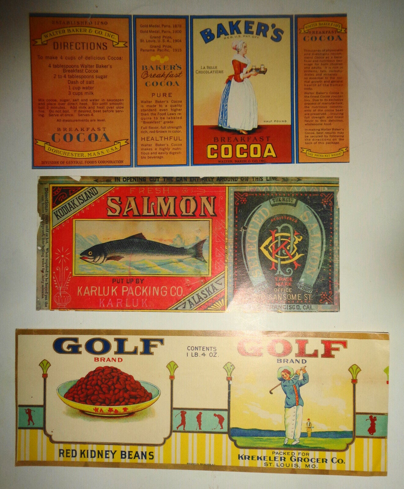 Lot of 3 Food can labels: Baker's Cocoa, Kodiak Salmon reproduction, Golf Beans